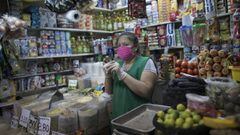 LIMA, PERU - APRIL 24: A shop assistant wears a face mask during coronavirus lockdown on April 24, 2020 in Lima, Peru. After 40 days of government-ordered lockdown and over 20,000 positive cases registered, President Vizcarra extended protective measures 