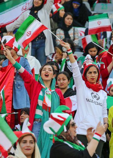 Iranian women cheer ahead of the World Cup Qatar 2022 Group C qualification football match between Iran and Cambodia at the Azadi stadium in the capital Tehran