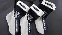 Christmas stockings hung over the wall behind the south end zone by Las Vegas Raiders fans
