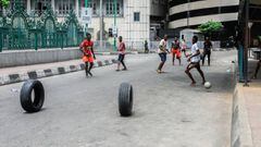 Boys play football in Lagos as a 14-day lockdown begins in Nigeria. 