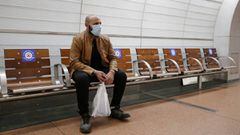 PARIS, FRANCE - APRIL 29: A passenger wearing a protective face mask sits next to seats with stickers that ream &quot;for our health, let this seat free&quot; to enforce social distancing in the metro as the lockdown continues due to the coronavirus (COVI
