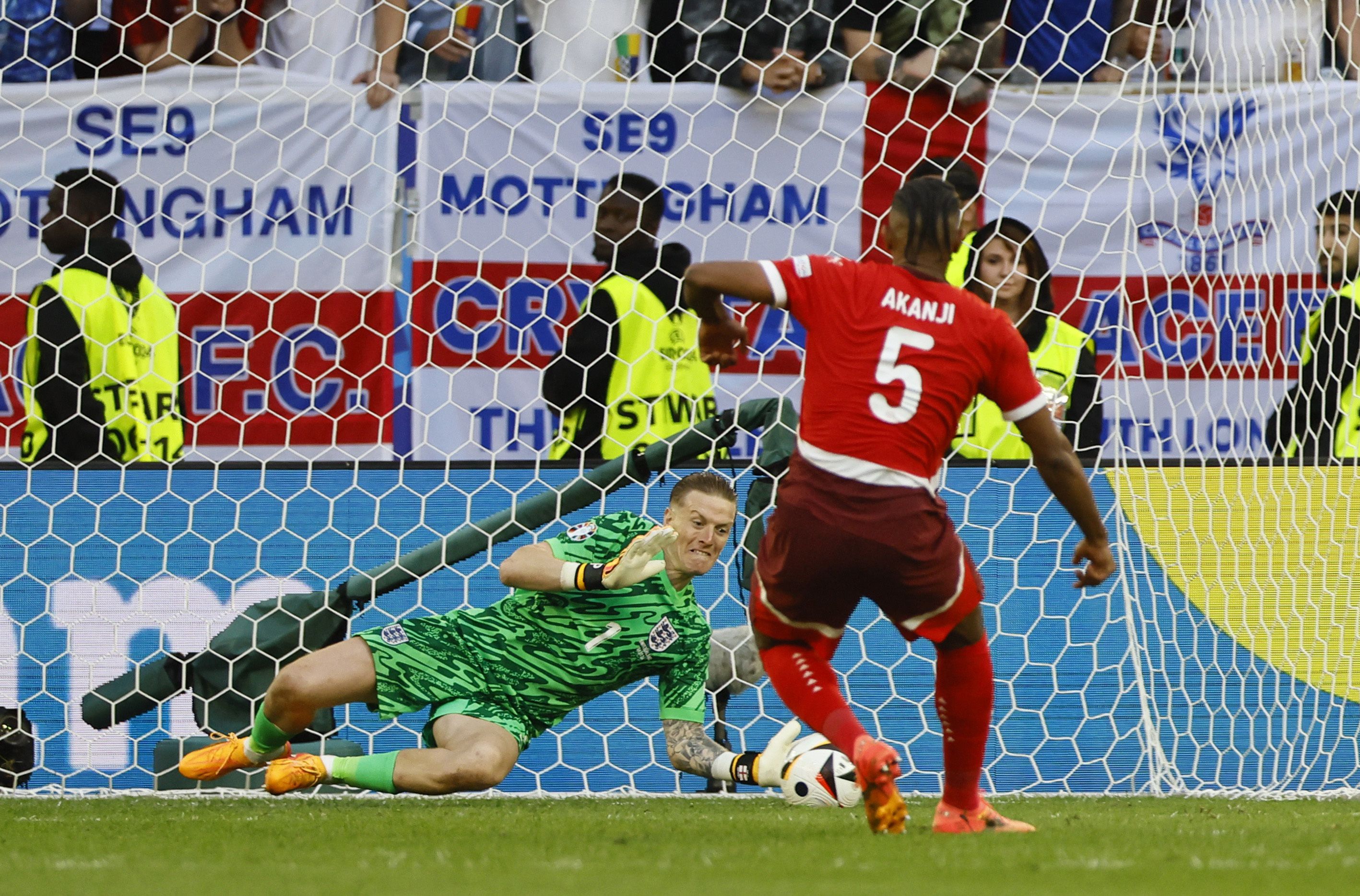 Soccer Football - Euro 2024 - Quarter Final - England v Switzerland - Dusseldorf Arena, Dusseldorf, Germany - July 6, 2024 England's Jordan Pickford saves a penalty in the shootout missed by Switzerland's Manuel Akanji REUTERS/Wolfgang Rattay