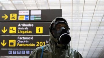 A passenger wearing protective garments arrives at the Josep Tarradellas Barcelona-El Prat Airport, after the Spanish government announced that from May 15th all people entering the country will have to go under quarantine for two weeks, amid the coronavi