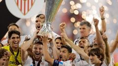 Sevilla's players celebrate with the trophy on the podium after winning the UEFA Europa League final football match between Sevilla FC and AS Roma at the Puskas Arena in Budapest on May 31, 2023. (Photo by Odd ANDERSEN / AFP)