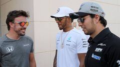 Mercedes&#039; British driver Lewis Hamilton (C) speaks with McLaren Honda&#039;s Spanish driver Fernando Alonso (L) and Force India&#039;s Mexican driver Sergio Perez (R) during a practise session as part of the Formula One Bahrain Grand Prix on April 13, 2017, at the Sakhir circuit in the desert south of the Bahraini capital, Manama. / AFP PHOTO / KARIM SAHIB