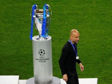 Soccer Football - Champions League Final - Manchester City v Chelsea - Estadio do Dragao, Porto, Portugal - May 29, 2021 Manchester City manager Pep Guardiola walks past the Champions League trophy after the match Pool via REUTERS/Susana Vera TPX IMAGES O