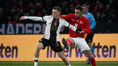 Germany's midfielder #17 Florian Wirtz (L) and Turkey's midfielder #08 Irfan Kahveci vie for the ball during the international friendly football match between Germany and Turkey at the Olympic Stadium in Berlin on November 18, 2023, in preparation for the UEFA Euro 2024 in Germany. (Photo by Tobias SCHWARZ / AFP)
