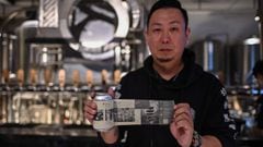 This photo taken on November 20, 2020 shows Wang Fan, founder of the No. 18 Brewery, posing with one of his beers with images of the city&#039;s fight against the Covid-19 coronavirus in Wuhan, China&#039;s central Hubei province. - When the coronavirus e