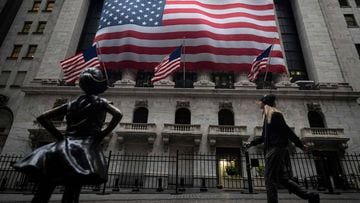 The Fearless Girl statue is seen in front of the New York Stock Exchange (NYSE) on April 30, 2020, in New York City. - Wall Street stocks opened lower Thursday following another spike of jobless claims in the wake of coronavirus shutdowns, offsetting stro