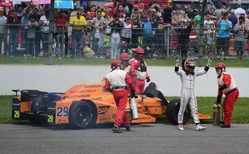 Fernando Alonso leaves his car after his engine failed at the 101st Indianapolis 500.