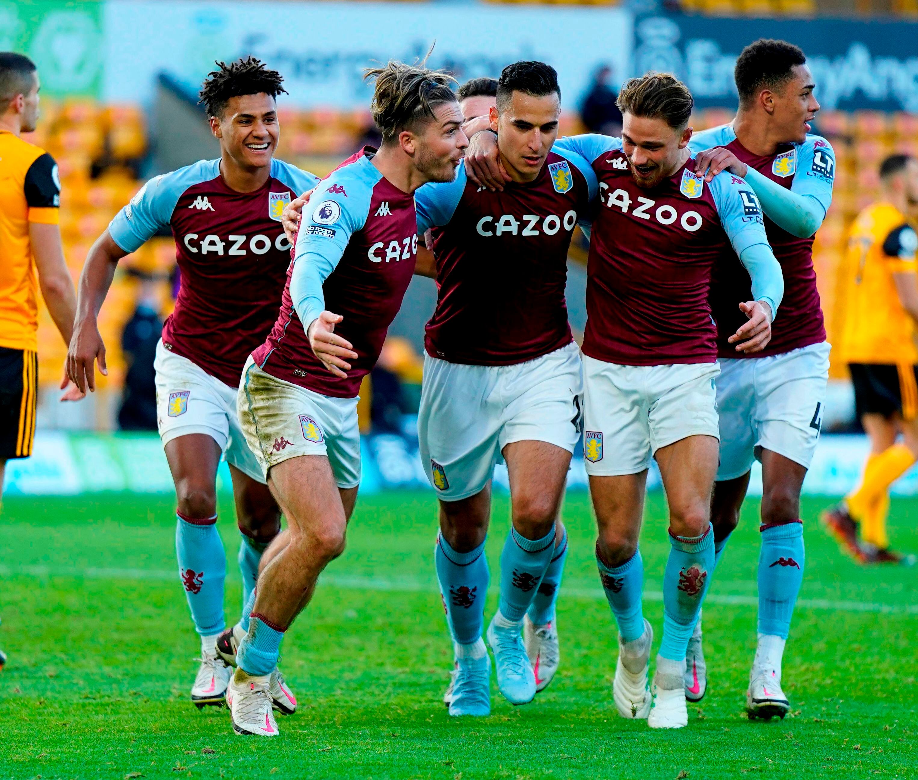 Aston Villa's Dutch striker Anwar El Ghazi (C) celebrates with teammates after he kicks the penalty and scores his team's first goal during the English Premier League football match between Wolverhampton Wanderers and Aston Villa at the Molineux stadium in Wolverhampton, central England on December 12, 2020. (Photo by Tim Keeton / POOL / AFP) / RESTRICTED TO EDITORIAL USE. No use with unauthorized audio, video, data, fixture lists, club/league logos or 'live' services. Online in-match use limited to 120 images. An additional 40 images may be used in extra time. No video emulation. Social media in-match use limited to 120 images. An additional 40 images may be used in extra time. No use in betting publications, games or single club/league/player publications. / 
