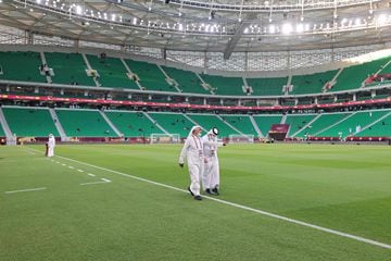 Qatari officials walk on the pitch ahead of the Al-Thumama Stadium 