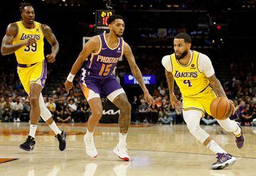 D.J. Augustin #4 of the Los Angeles Lakers handles the ball against Cameron Payne #15 of the Phoenix Suns during the first half of the NBA game at Footprint Center