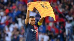 Paris Saint-Germain's French forward Kylian Mbappe celebrates scoring his team's second goal with holding up jersey of Paris Saint-Germain's Spanish goalkeeper Sergio Rico, who is in serious condition after a horse-riding accident, during the French L1 football match between Paris Saint-Germain (PSG) and Clermont Foot 63 at the Parc des Princes Stadium in Paris on June 3, 2023. (Photo by FRANCK FIFE / AFP)