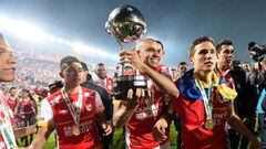 BOGOTA, COLOMBIA - DECEMBER 09: Sergio Otalvaro (C), Dario Rodriguez, and Luis Manuel Seijas (R) of Independiente Santa Fe lift the trophy to celebrate after winning the Copa Sudamericana 2015 after a second leg final match between Independiente Santa Fe and Huracan as part of Copa Sudamericana 2015 at Nemesio Camacho El Campin Stadium on December 09, 2015 in Bogota, Colombia. (Photo by Gabriel Aponte/LatinContent/Getty Images)