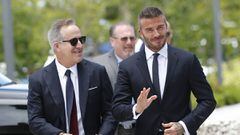 David Beckham, right, and partner Jorge Mas, left, prepare to greet fans at Regatta Park next to City Hall before a public hearing for their proposed Major League Soccer stadium and commercial development, Thursday, July 12, 2018, in Miami. (AP Photo/Wilfredo Lee)