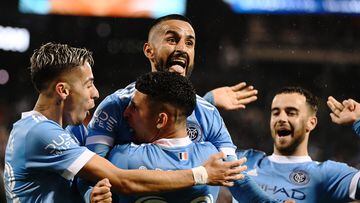 Oct 17, 2022; Queens, New York, USA;  New York City FC midfielder Maximiliano Moralez, top, celebrates his goal in the 69th minute with teammates Santiago Rodriguez, bottom, and New York City FC midfielder Gabriel Pereira, left, during the second half of a MLS Eastern Conference quarterfinal match against Inter Miami CF at Citi Field. Mandatory Credit: Mark Smith-USA TODAY Sports
