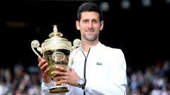 FILE PHOTO: Tennis - Wimbledon - All England Lawn Tennis and Croquet Club, London, Britain - July 14, 2019  Serbia&#039;s Novak Djokovic poses with the trophy as he celebrates winning the final against Switzerland&#039;s Roger Federer  Laurence Griffiths/