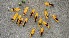 This aerial view image shows surfers from a local Surf Camp with their instructors as they warm up ahead of a surfing session on September 30, 2020 in Klitmoller, Denmark. - On Denmark&#039;s rugged western coast, far from paradise islands in the tropics,