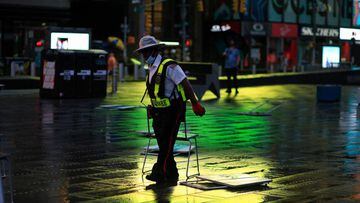 Workers remove chairs in Times Square as Tropical Storm Henri approaches, in New York on August 22, 2021.