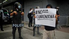 A demonstrator holds a sign that reads &quot;No to quarantine&quot; as he protests against the lockdown, amid the spread of the coronavirus disease (COVID-19 in Lima, Peru January 31, 2021. REUTERS/Sebastian Castaneda
