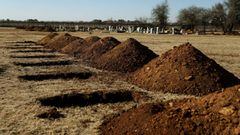FILE PHOTO: Freshly dug graves are seen amid a nationwide coronavirus disease (COVID-19) lockdown, at the Honingnestkrans cemetery, north of Pretoria, South Africa  July 14, 2020. REUTERS/Siphiwe Sibeko/File Photo