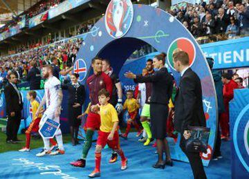 Cristiano Ronaldo and Aron Gunnarsson lead out their respective teams. Cristiano seems distracted.