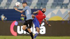 Uruguay&#039;s Matias Vecino, left, and Chile&#039;s Arturo Vidal battle for the ball during a Copa America soccer match at Arena Pantanal stadium in Cuiaba, Brazil, Monday, June 21, 2021. (AP Photo/Andre Penner)