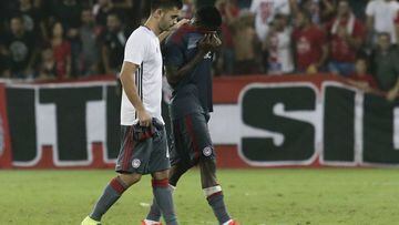 Olympiakos players Sasa Zdjelarin, left, and Ideye Brown leave the pitch dejected after losing to Hapoel Beer-Sheva Champions league qualifying match in Beersheba