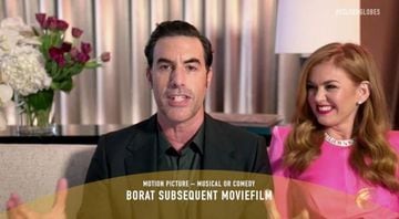 Sacha Baron Cohen, with Isla Fisher, accepts the Best Picture - Musical/Comedy award for Borat Subsequent Moviefilm.