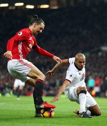 Zlatan Ibrahimovic of Manchester United and Younes Kaboul of Watford compete for the ball during the Premier League match between Manchester United and Watford