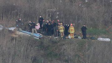  Bodies moved around as first responders and investigators examine the fatal helicopter crash that took the lives of Kobe Bryant and his Daughter and seven others. The Crash took place on a hillside in Calabassas as the chopper was bringing the NBA legend