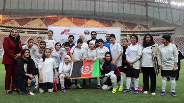 Afghan players pose for a picture after a friendly football match between the women football teams of Qatar and Afghanistan at the Khalifa International Stadium in Doha on November 10, 2021. - Afghan women athletes fled Taliban rule on October 20, 2021 in