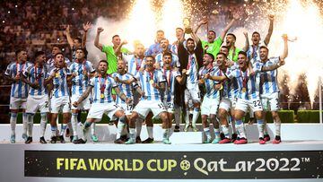 FILE PHOTO: Soccer Football - FIFA World Cup Qatar 2022 - Final - Argentina v France - Lusail Stadium, Lusail, Qatar - December 18, 2022 Argentina's Lionel Messi celebrates with the trophy and teammates after winning the World Cup REUTERS/Carl Recine/File Photo