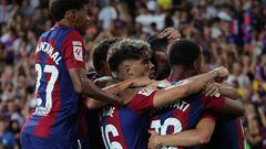 Barcelona's players celebrate their team's first goal during the Spanish Liga football match between FC Barcelona and Cadiz CF at the Lluis Companys Olimpic Stadium in Barcelona on August 20, 2023. (Photo by LLUIS GENE / AFP)