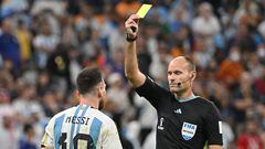 Spanish referee Antonio Mateu Lahoz shows a yellow card to Argentina's forward #10 Lionel Messi during the Qatar 2022 World Cup quarter-final football match between Netherlands and Argentina at Lusail Stadium, north of Doha, on December 9, 2022. (Photo by Alberto PIZZOLI / AFP)