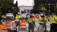 Construction workers repair a street near the White House in Washington, DC on August 31, 2021 as part of new infrastructure.
