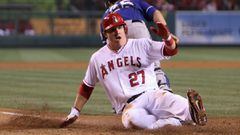 (FILES) In this file photo taken on June 1, 2012 Mike Trout #27 of the Los Angeles Angels of Anaheim slides safely past catcher Mike Napoli #25 of the Texas Rangers and scores a run in the sixth inning at Angel Stadium of Anaheim in Anaheim, California. -