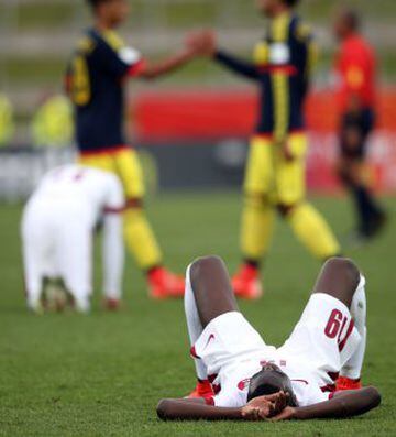 Qatar's Almoez Ali lies dejected on the field after the FIFA Under-20 World Cup football match between Qatar and Colombia in Hamilton on May 31, 2015.\xA0       AFP PHOTO / Michael Bradley