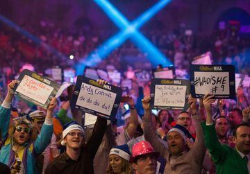 Fans hold up messages ahead of the PDC World Championship darts final between Netherlands' Michael van Gerwen and Scotland's Gary Anderson