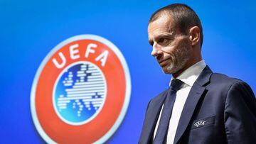 UEFA president Aleksander Ceferin walks past a sign with the UEFA logo after attending a press conference following a meeting of the executive committee at the UEFA headquarters, in Nyon, Switzerland on December 4, 2019. (Photo by Fabrice COFFRINI / AFP)