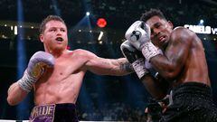 LAS VEGAS, NEVADA - SEPTEMBER 30: Saul "Canelo" Alvarez of Mexico (purple/gold trunks) trades punches with�Jermell Charlo (black trunks)�during their�super middleweight title fight at T-Mobile Arena on September 30, 2023 in Las Vegas, Nevada.   Sarah Stier/Getty Images/AFP (Photo by Sarah Stier / GETTY IMAGES NORTH AMERICA / Getty Images via AFP)