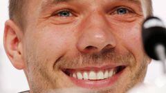 Lukas Podolski smles as he receives applause for an answer during a press conference at the base camp of the German national soccer team in Evian-Les-Bains, France, Tuesday, June 14, 2016.
