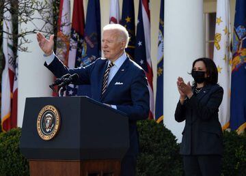 US President Joe Biden, with Vice President Kamala Harris (R), speaks about the American Rescue Plan in the Rose Garden of the White House in Washington, DC, on March 12, 2021. (Photo by Olivier DOULIERY / AFP)