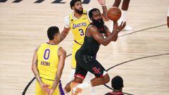 Houston Rockets guard James Harden (13) passes the ball between Los Angeles Lakers forward Kyle Kuzma (0) and forward Anthony Davis (3) during the second half of an NBA basketball game Thursday, Aug. 6, 2020, in Lake Buena Vista, Fla. (Kim Klement/Pool Ph