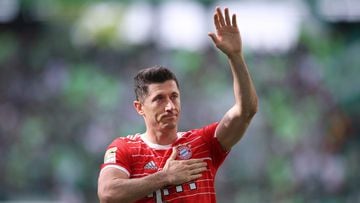 Bayern Munich's Polish forward Robert Lewandowski greets and holds a hand on his heart after the German first division Bundesliga football match VfL Wolfsburg v Bayern Munich in Wolfsburg, northern Germany, on May 14, 2022. (Photo by Ronny Hartmann / AFP) / DFL REGULATIONS PROHIBIT ANY USE OF PHOTOGRAPHS AS IMAGE SEQUENCES AND/OR QUASI-VIDEO