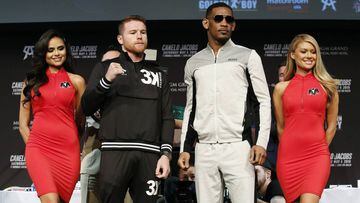 Canelo Alvarez, center left, and Daniel Jacobs, center right, pose for photographers at a news conference for their middleweight title boxing match Wednesday, May 1, 2019, in Las Vegas. The two are scheduled to fight Saturday in Las Vegas. (AP Photo/John Locher)