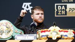 Undisputed super middleweight champion Canelo Alvarez raises a fist during a news conference