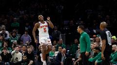 New York Knicks guard Immanuel Quickley (5) celebrates after a basket in front of the Boston Celtics bench during the overtime period at TD Garden.