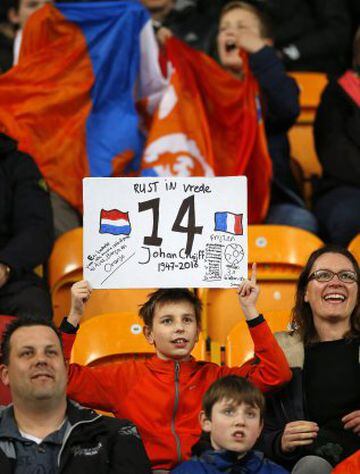 A boy holds a sign "rest in peace" and the number 14, to commemorate deceased legendary soccer player Johan Cruyff who played with number 14, prior to the international friendly soccer match between The Netherlands and France at the ArenA stadium in Amste